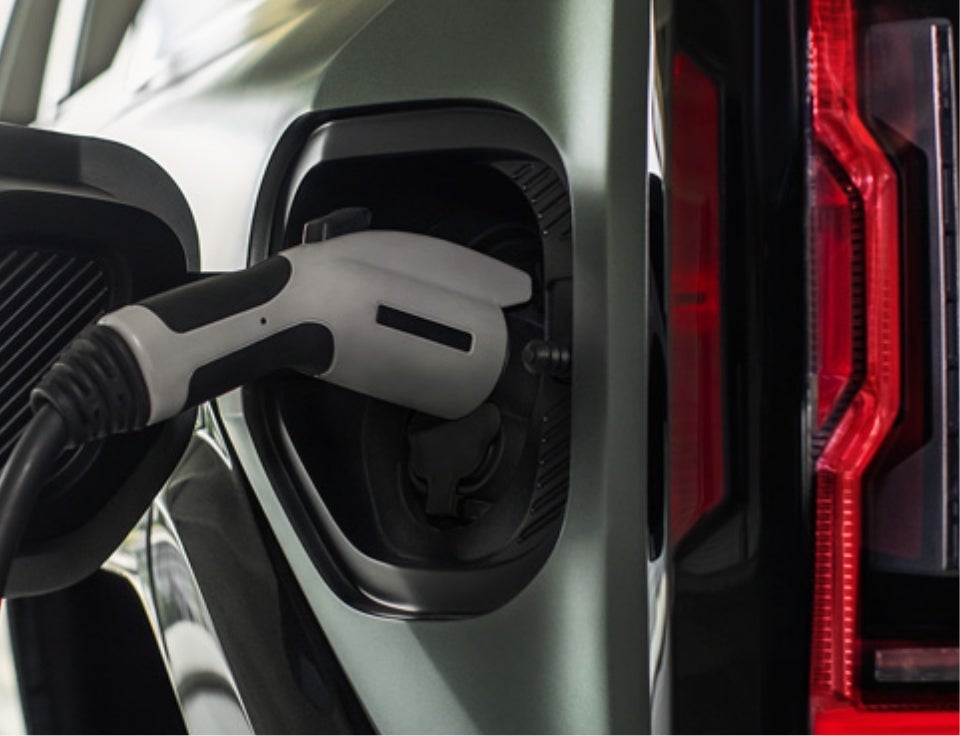 Close up of charging port with charger plugged in on a GMC Hummer EV SUV - Homan GMC of Ripon in Ripon WI